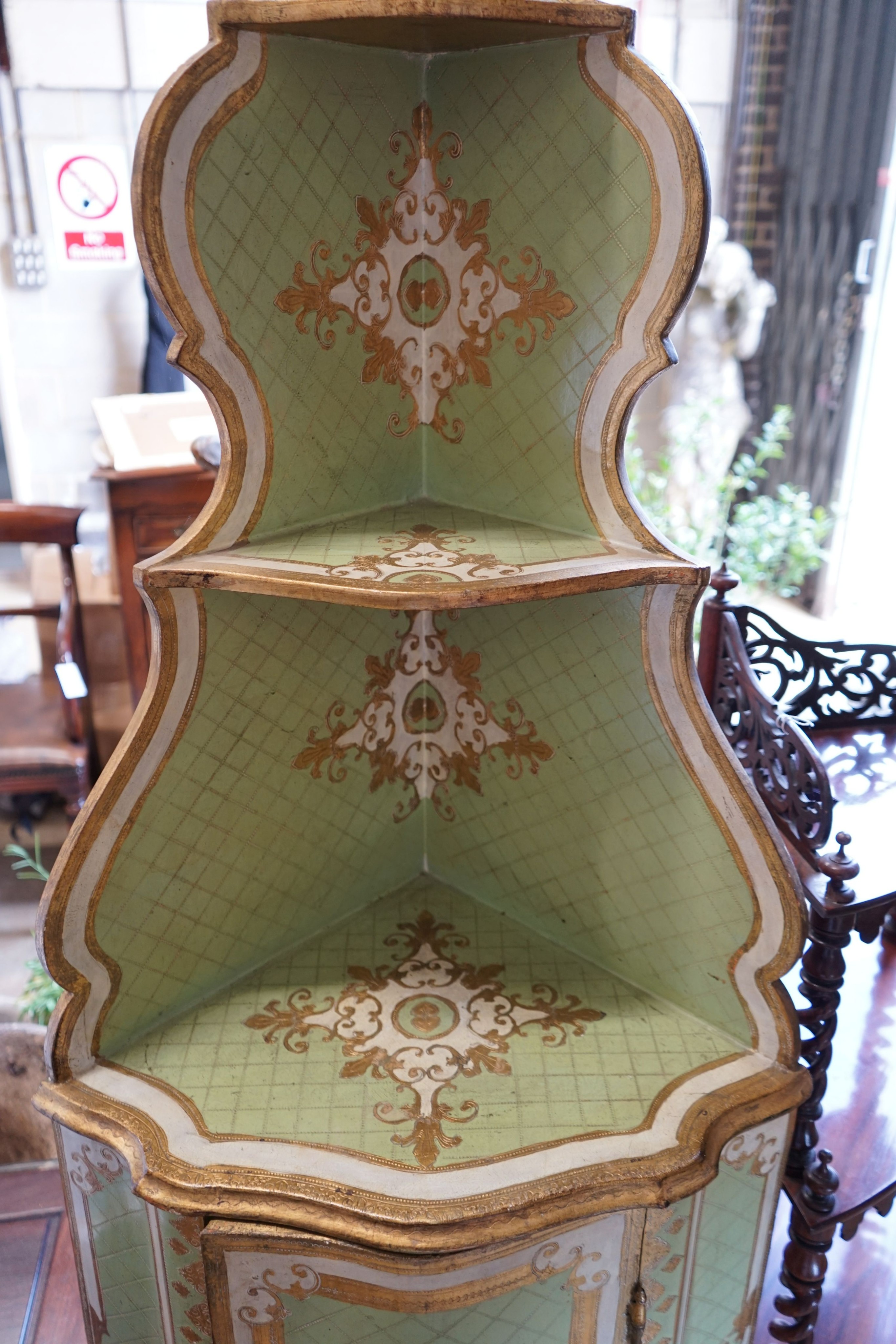 An Italian painted parcel gilt standing corner cabinet, width 57cm, depth 39cm, height 189cm